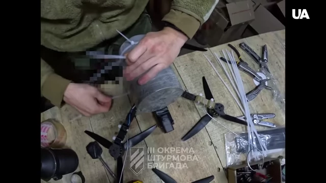 A soldier assembling an FPV drone from commercial parts