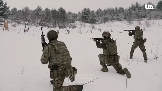 Soldiers training with rifles in a snowy environment