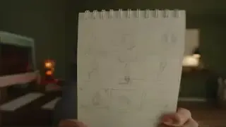 Riza showing a sketch from her notebook