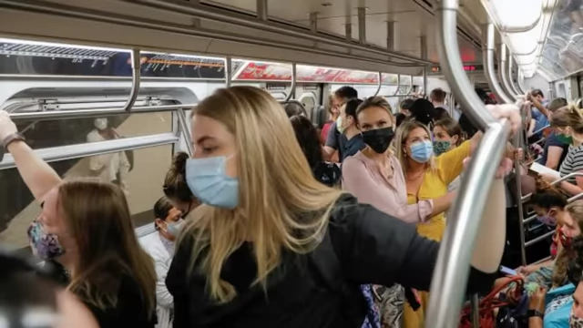 Commuters packed in a subway car, illustrating crowded public transport