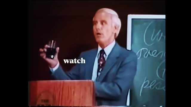 Jim Rohn holding a glass of coffee, emphasizing the importance of "watching your coffee" by carefully selecting mental inputs.