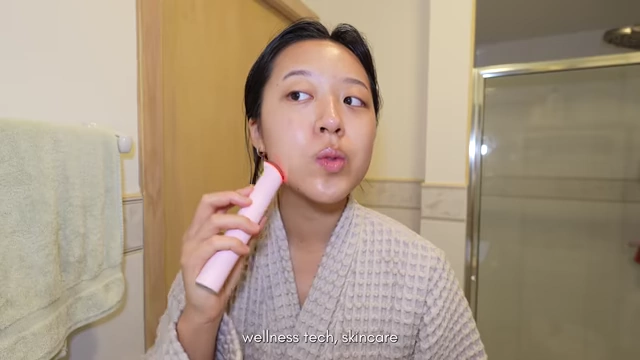 Using a facial massage device, another example of a wellness gadget.