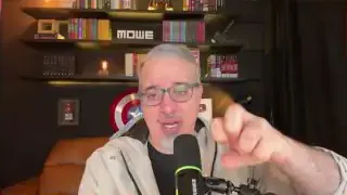 A speaker with glasses and a microphone, gesturing with his hands to emphasize a point about financial concepts.