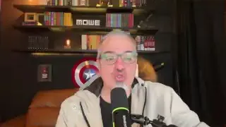 The speaker explaining how a potential crisis may lead to the adoption of digital currencies.