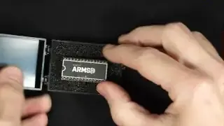 The ARM SID chip, showcasing its compact, original-SID-like form factor, within its protective packaging.