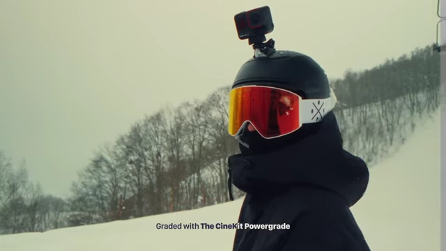 Snowboarder with red goggles creating intentional color contrast against the snow