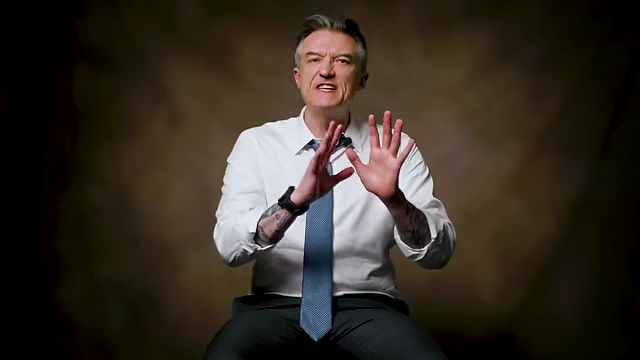 James Sexton emphasizing that 56% of marriages end in divorce with a hand gesture meaning "stop".