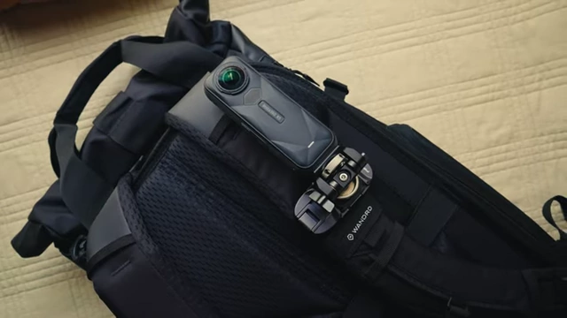 A 360-degree camera mounted on a backpack strap, ready for hands-free recording.