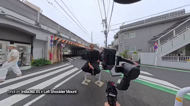 A shot from a 360-degree camera showing the creator filming a subject, capturing the entire environment.