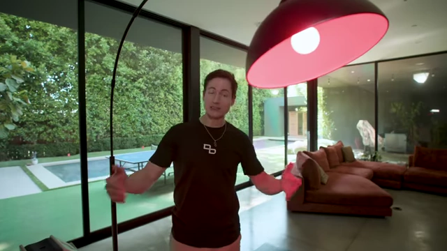 Bryan Johnson shows a dim red LED floor lamp he uses to create a calming atmosphere before bed.
