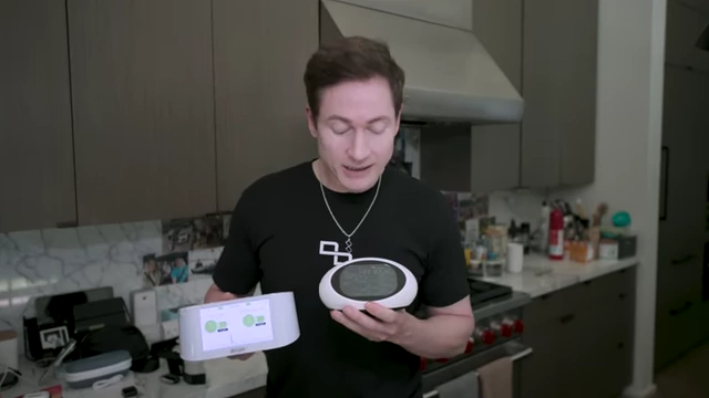 Bryan Johnson demonstrates two different indoor air quality monitors.