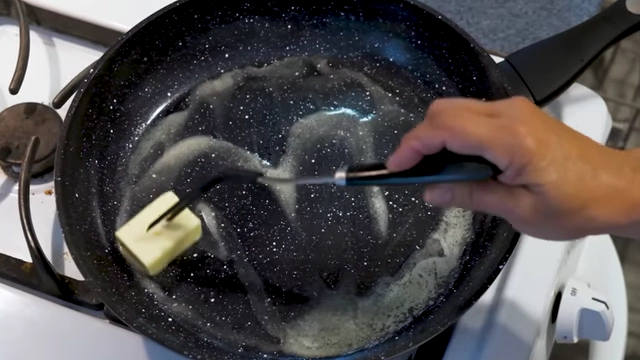 A non-stick pan with melting butter.