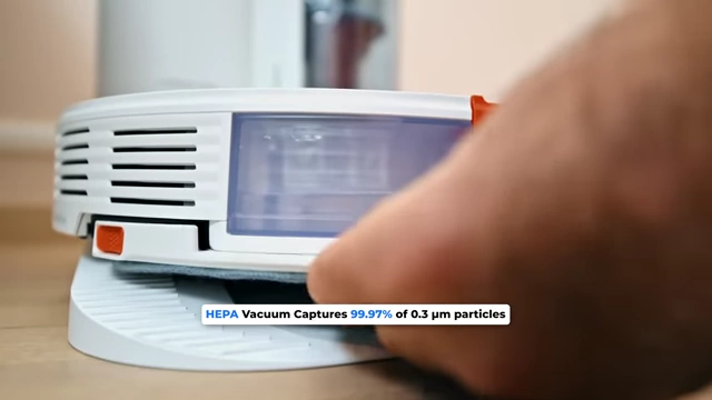 A robot vacuum cleaner with on-screen text highlighting its HEPA filter's ability to capture 99.97% of 0.3 µm particles.