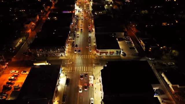 An aerial view of a busy road at night, representing environmental noise that can disrupt sleep.