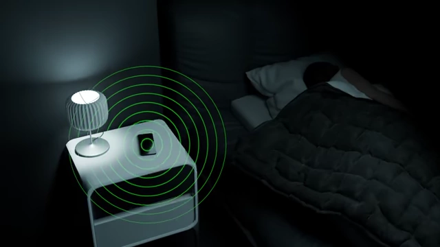 An animation depicts a phone emitting electromagnetic waves next to a sleeping person, illustrating potential EMF exposure.
