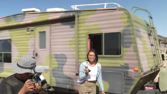 Emily Zang, a writer-director, is shown talking to Derek Muller, highlighting an unconventional hiring process.