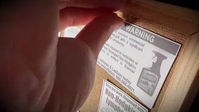 A close-up of a "WARNING" notice about Roundup (Monsanto product) and Non-Hodgkin Lymphoma, symbolizing the sensitive topics Veritasium now tackles with legal support.