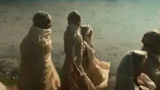 Pilgrims making a difficult journey across a desert in Apple TV's Foundation series.