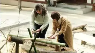 People performing a handwashing ritual at a Shinto shrine, transforming an ordinary action into a sacred one.