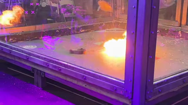 A BattleBot with a flamethrower ignites a burst of fire.