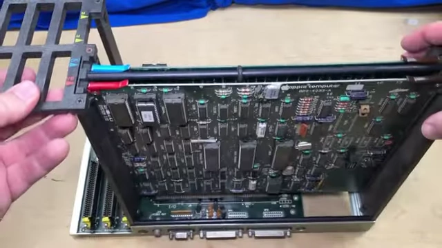 Holding a Lisa board, demonstrating its modularity