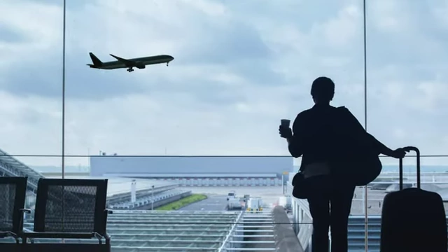 Silhouette of a person with luggage at an airport