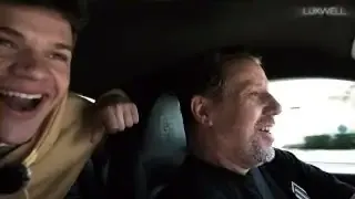 A son and his father share a joyful moment in their new Porsche 911.