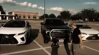 Multiple new vehicles, including a Toyota Tundra, line a street as a young man prepares to surprise his family with their new cars.