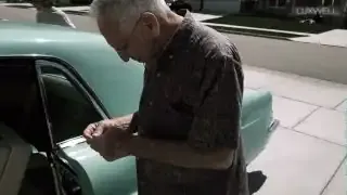A grandfather receives the keys to his dream 1956 Lincoln Continental Mark and inspects them.