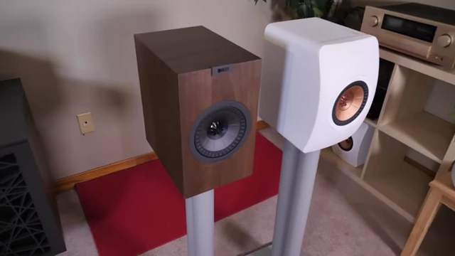 A KEF Q150 (left) next to a KEF LS50 Meta (right) on speaker stands.