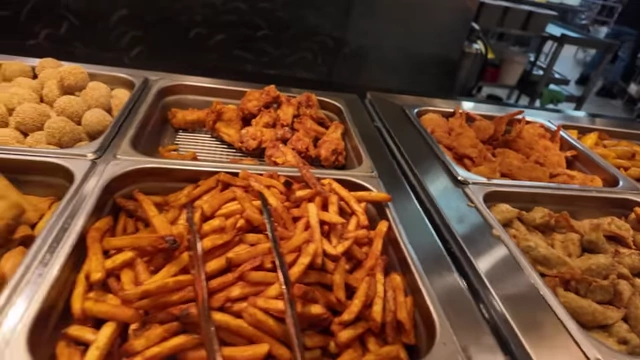 Trays of golden fries and crispy chicken wings.