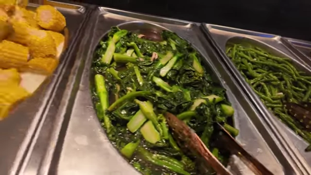 Stir-fried bok choy among other cooked green vegetables.