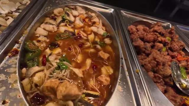 Spicy fish and tofu dish alongside other hot items.