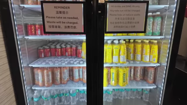 A fridge stocked with various canned and bottled beverages for the all-you-can-drink station.