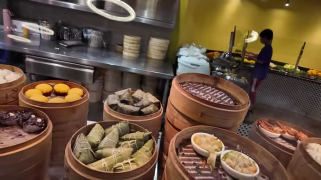 A variety of dim sum, including steamed buns and other small bites.