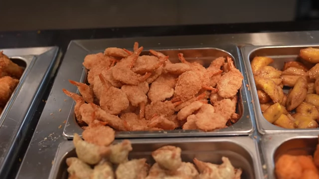 A large tray of crispy coconut shrimp.