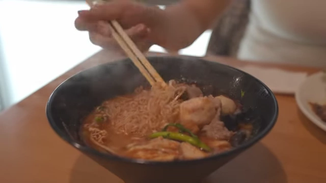 A steaming bowl of Malatang with a Thai soup base and various ingredients.