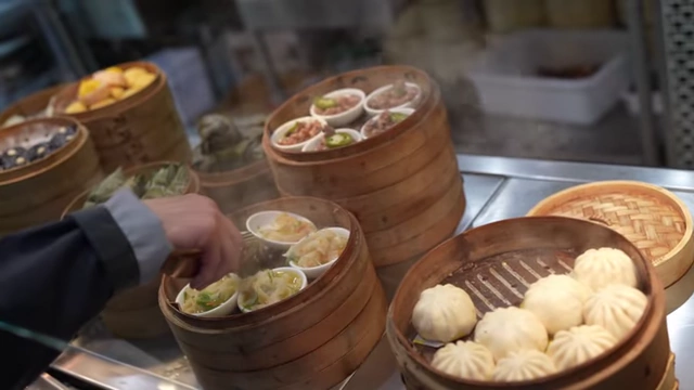 The dim sum station showing various steamed buns and other items.
