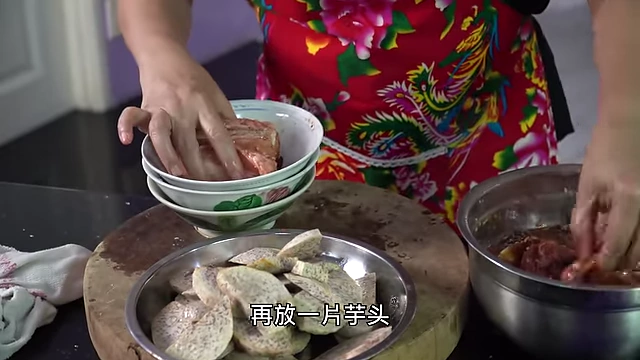 Arranging pork and taro slices alternately in a bowl, skin-side down for presentation.