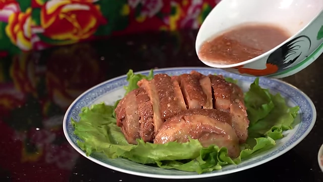 Pouring the concentrated sauce over the plated dish.