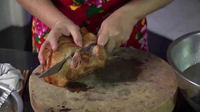 Slicing the soaked pork belly to an appropriate thickness.