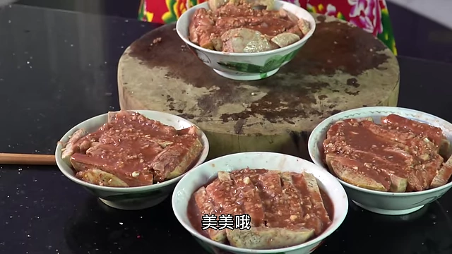 Four bowls prepared with layered pork belly and taro.