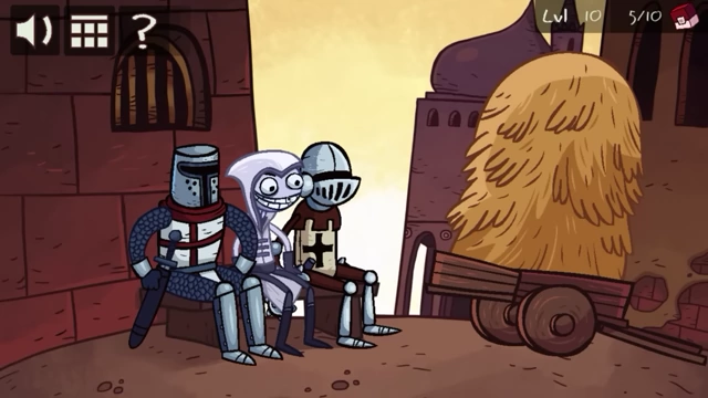 Two knights are seated next to a large hay cart