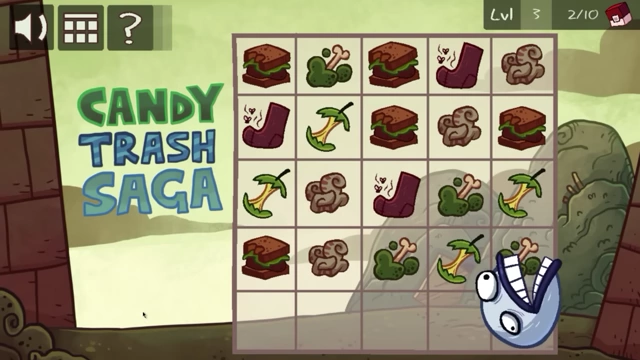A monster hand emerges from the bottom of the screen to manipulate items on the game board