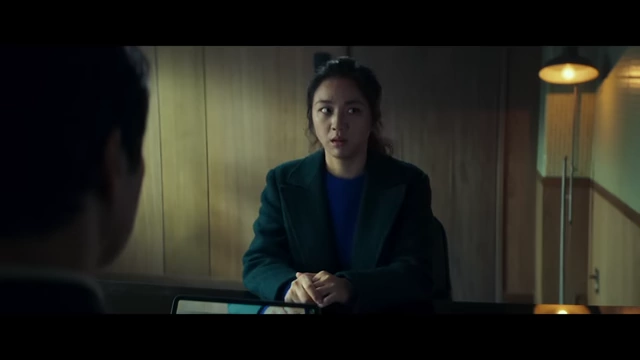 Seo-rae, the suspect, is interrogated by Hae-jun, the detective, in a seemingly ordinary room.