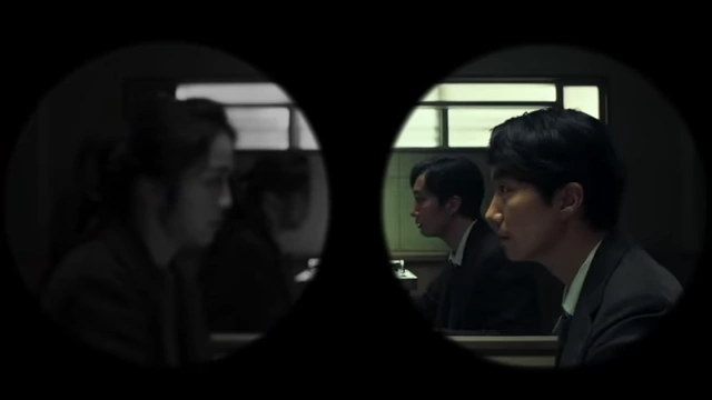 The view through binoculars isolates Hae-jun and Seo-rae, highlighting how the visible world creates disconnection.