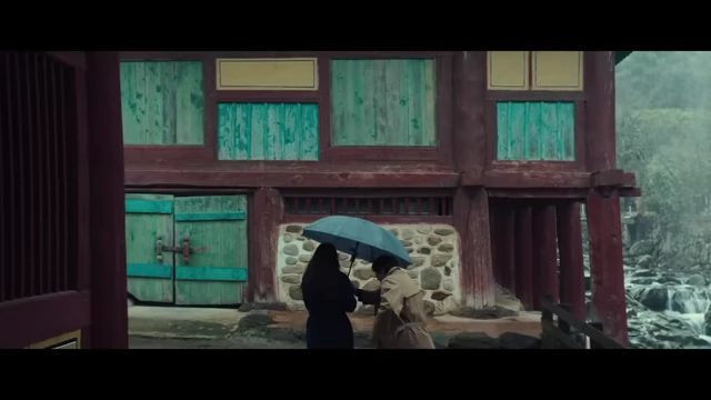 A building with prominent turquoise elements, symbolizing the blend of land and water (mountain and ocean) where the characters interact.