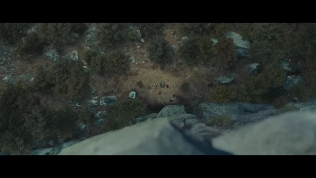 A bird's eye view from the cliff shows people gathered on the ground, symbolizing a fall into mystery.