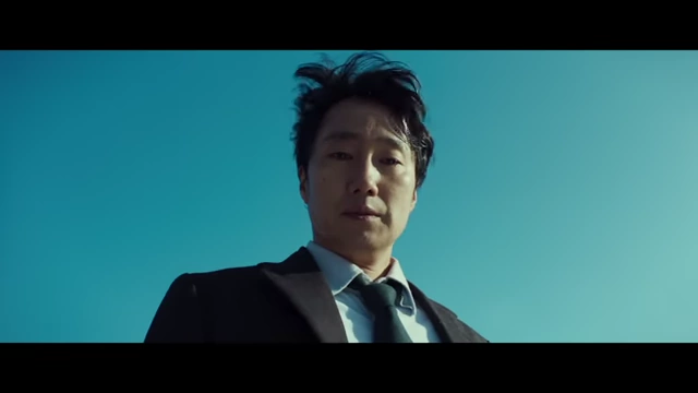 Hae-jun looks down from a height, visually representing a "peak" moment before a metaphorical fall into the ocean.