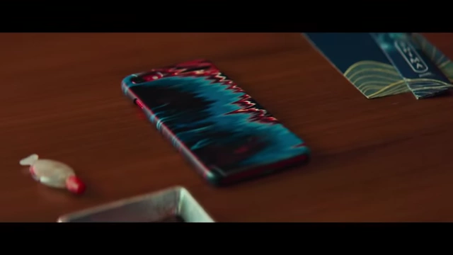 A phone with a vibrant, abstract case design, representing the "problem" that Hae-jun advises Seo-rae to discard.